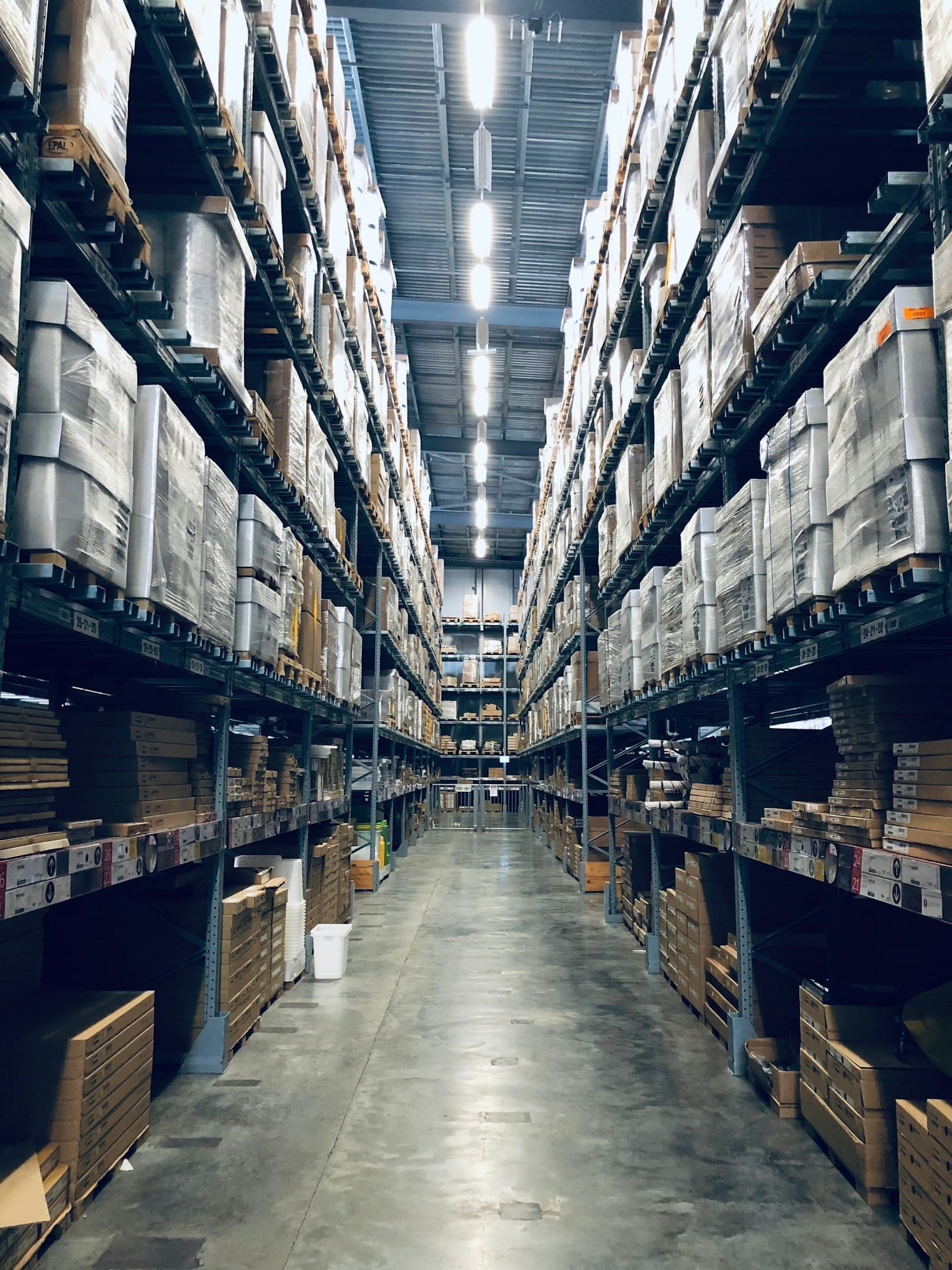 Racked warehouse aisles holding imported inventory